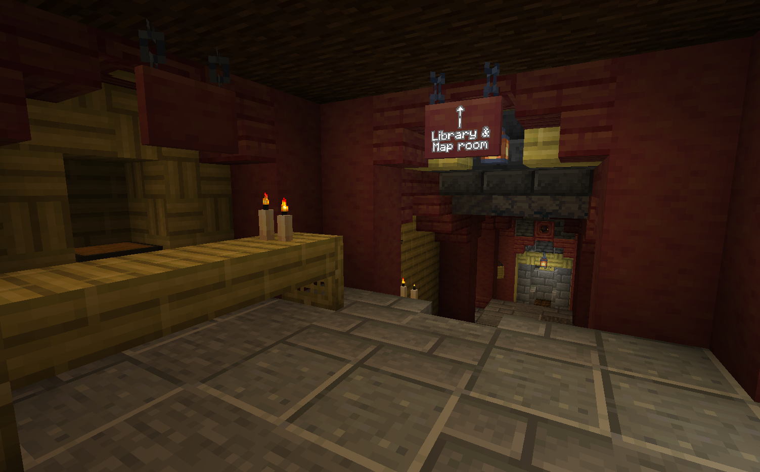 An underground hallway with a sign pointing to a library and a map room